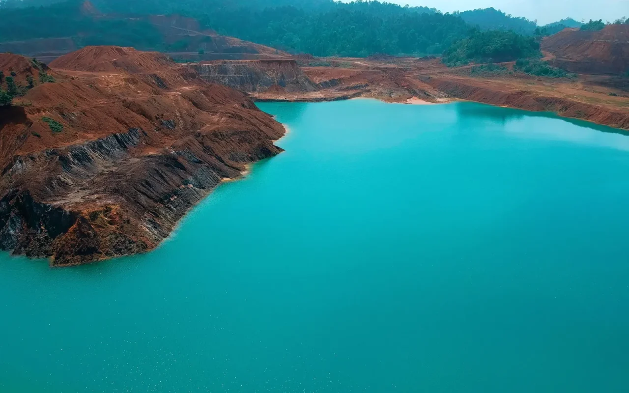 Cava de mineração com lago de água turquesa, vista do alto